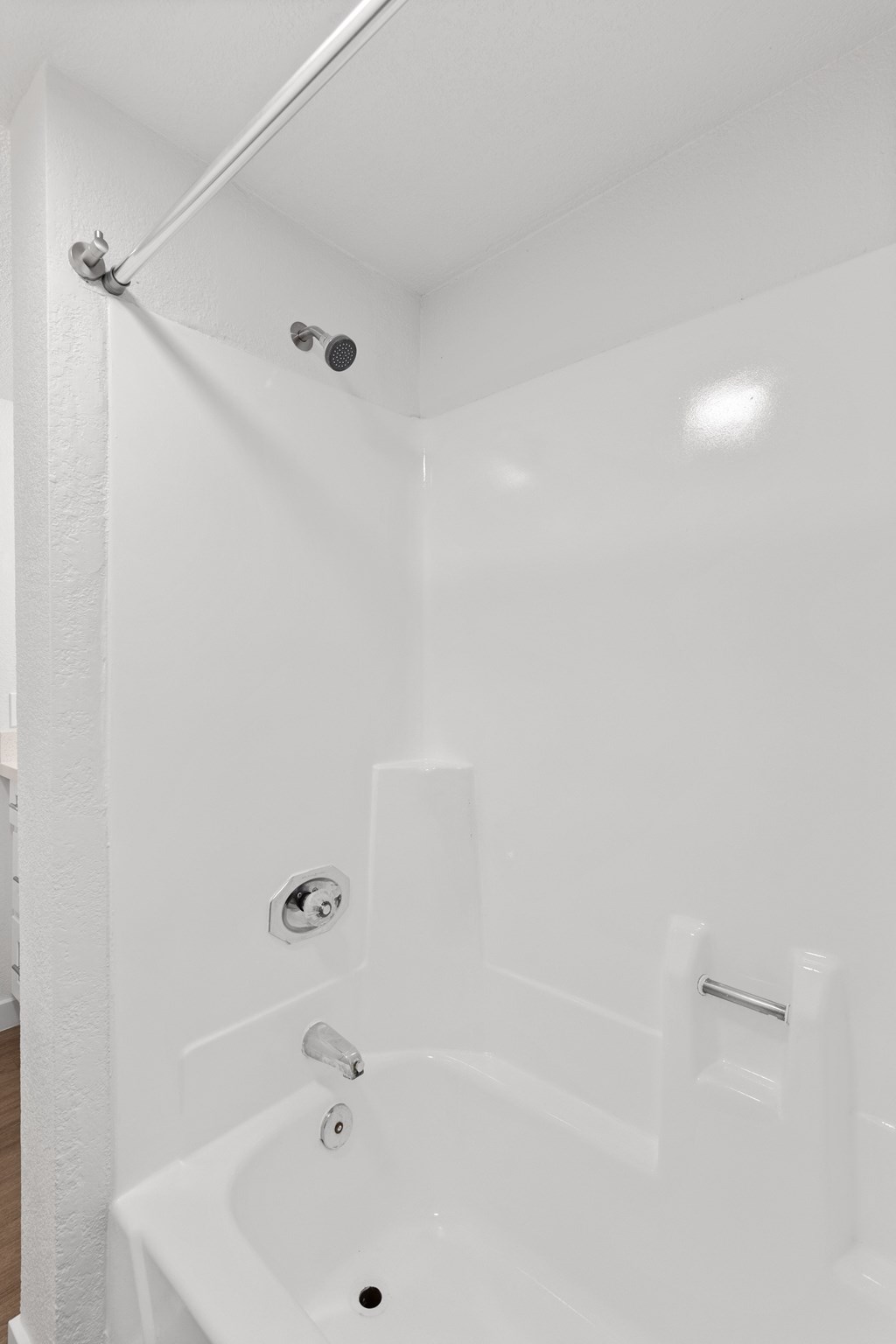 a white bathroom with a tub and a shower curtain