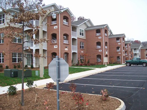 A stop sign is in front of apartment buildings.