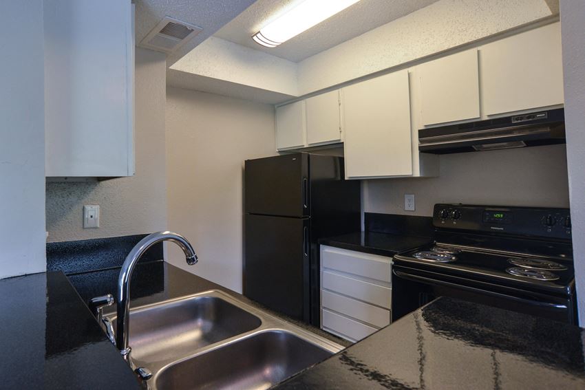 a kitchen with a sink and a refrigerator