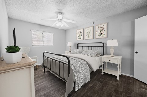 a bedroom with a bed and a ceiling fan
