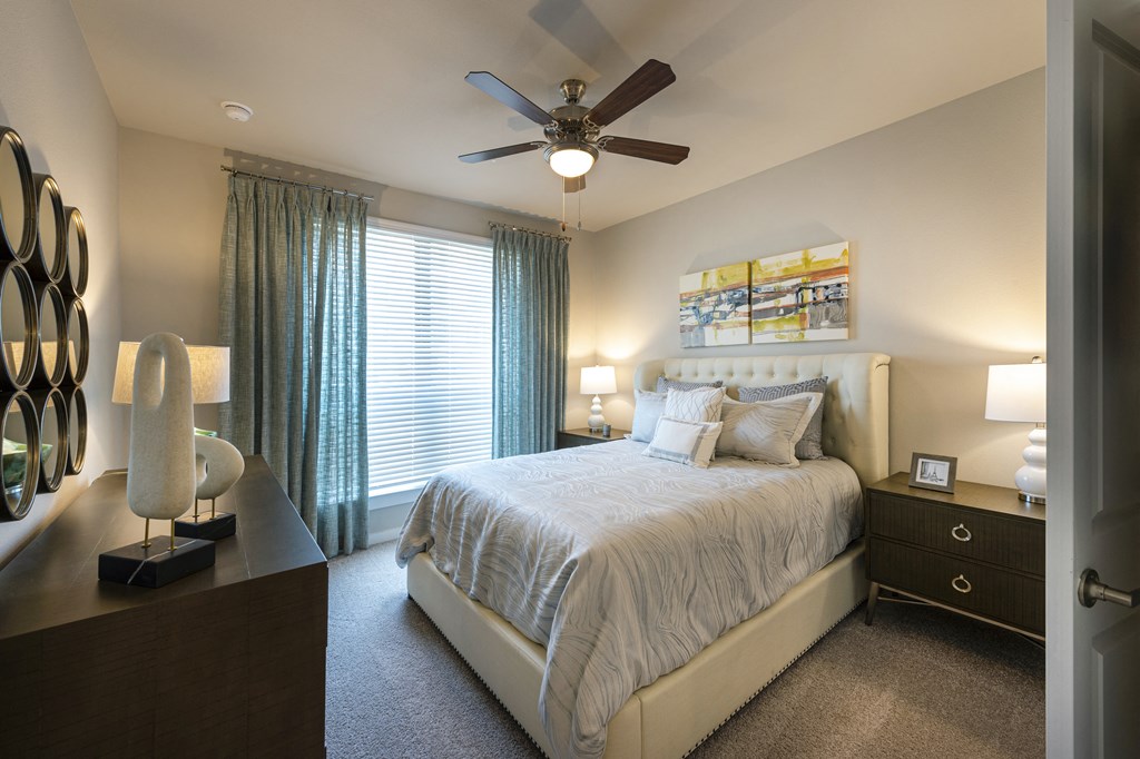 a bedroom with a bed and a ceiling fan