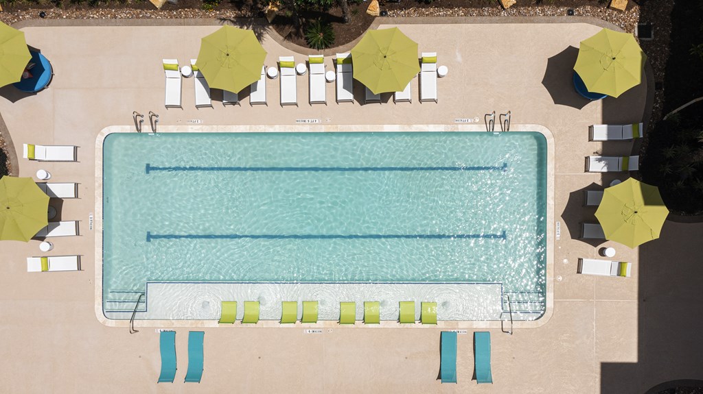 a rendering of a pool with umbrellas and chairs around it