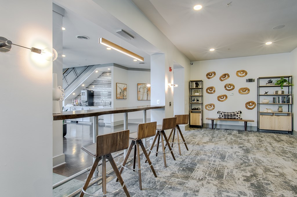 A modern kitchen with a dining table and chairs.