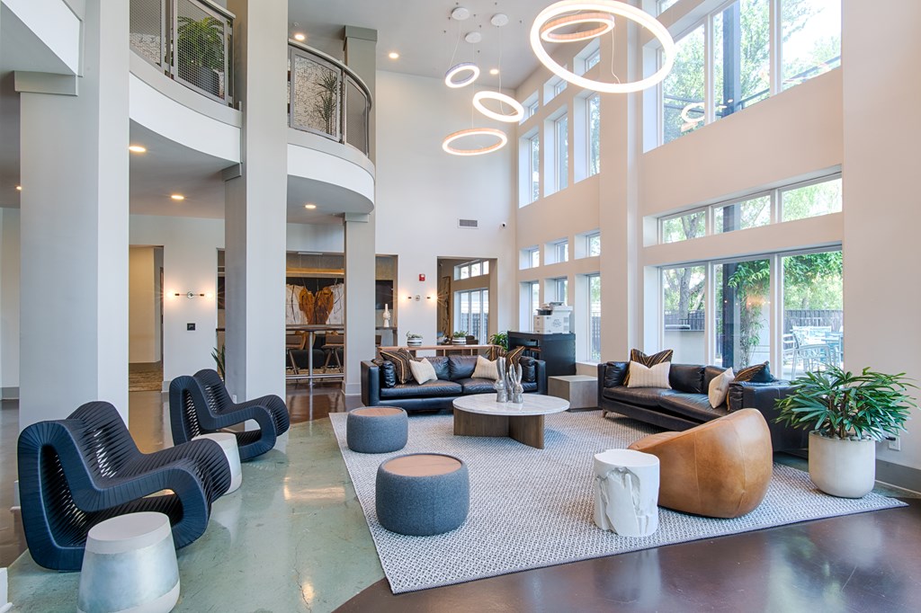 A spacious lobby with a variety of seating options and a large window.