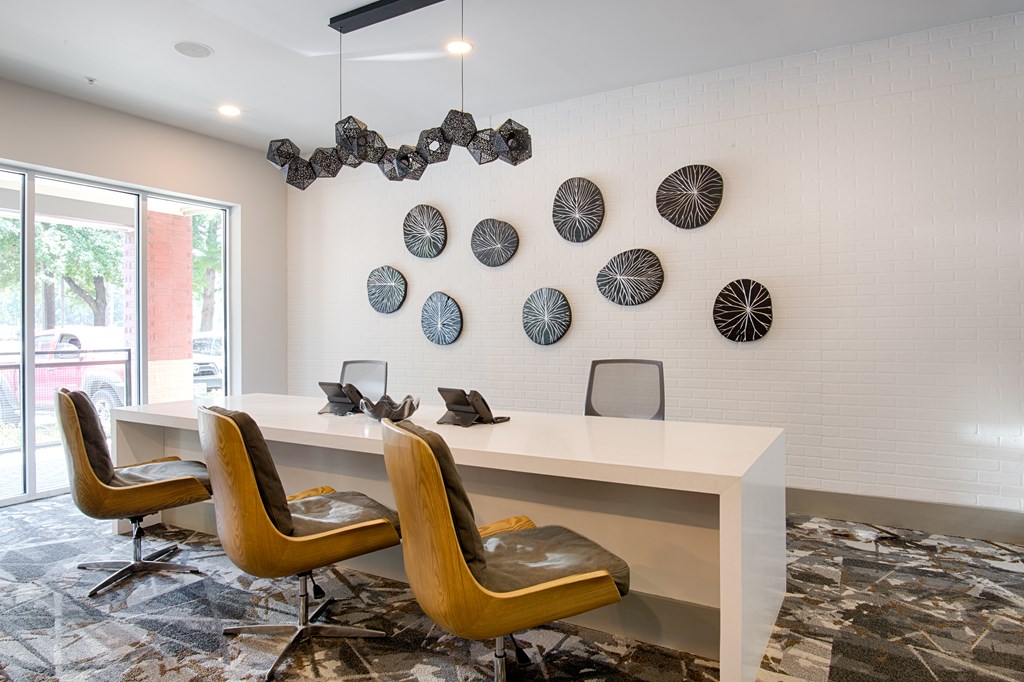 A white desk with a chair in front of it and a wall with circular decorations.