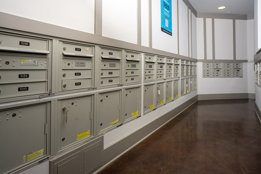 A long row of metal filing cabinets with yellow labels on them.