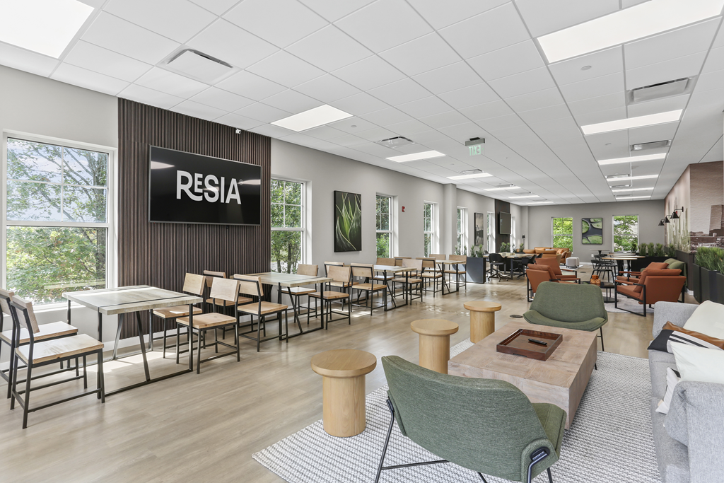 A conference room with a sign that says "RESIA" on the wall.