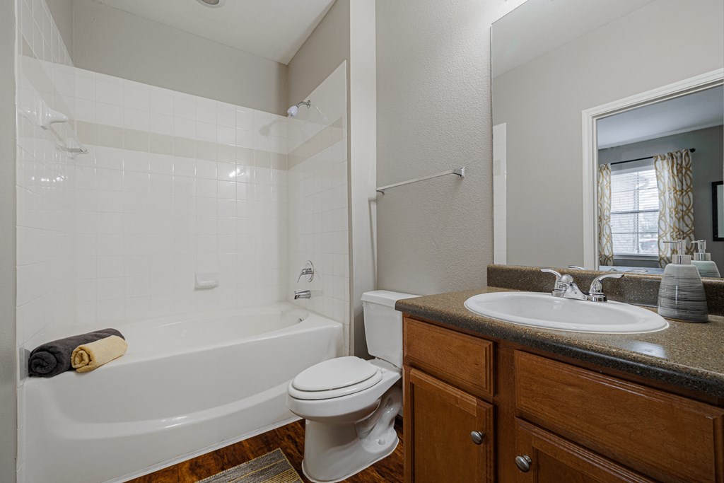 a bathroom with a sink toilet and bath tub