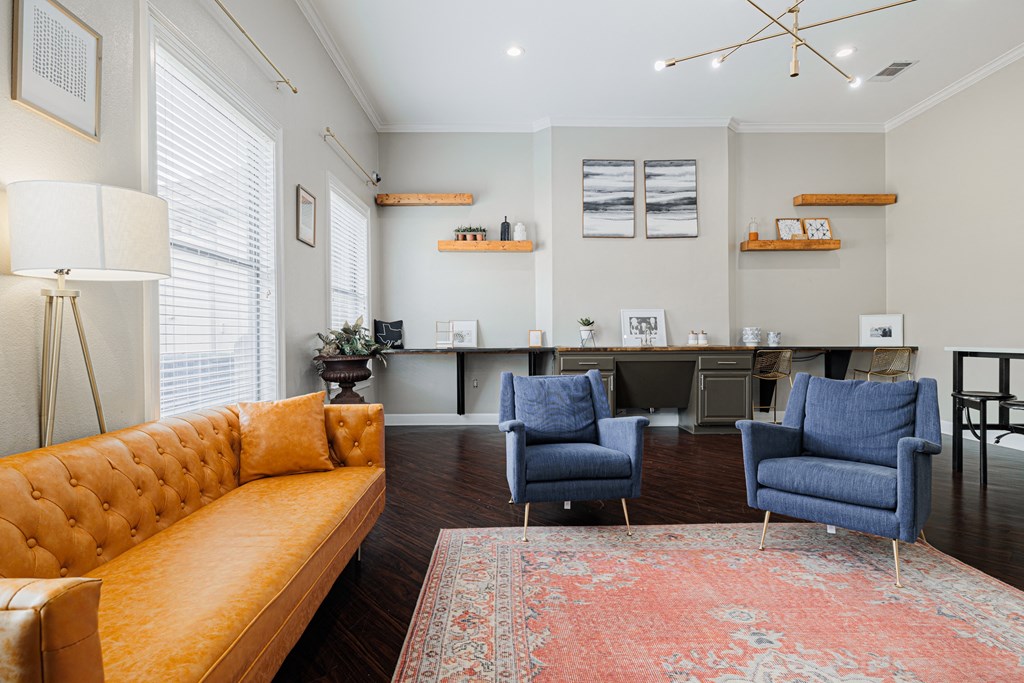 a living room with a yellow couch and two blue chairs
