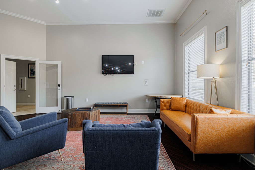 a living room with couches and chairs and a television
