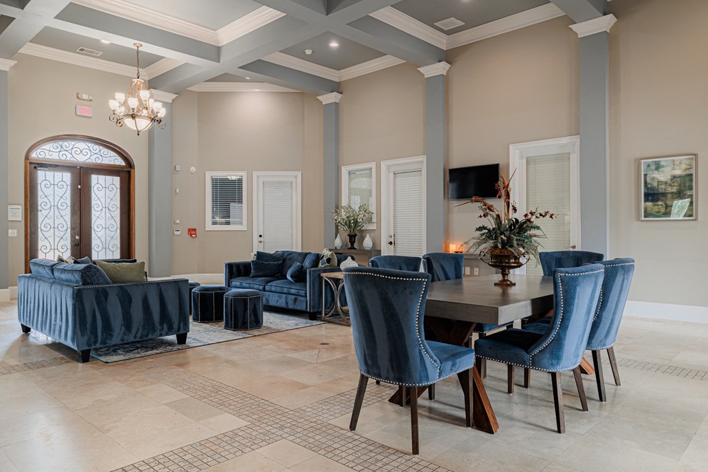 a dining room and living room with blue chairs and a table