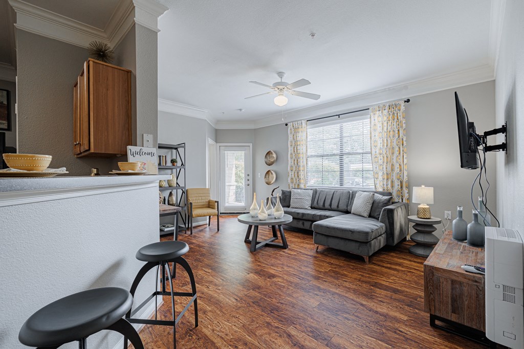 an open living room with furniture and a large window