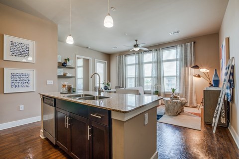 A kitchen with a sink and a counter.