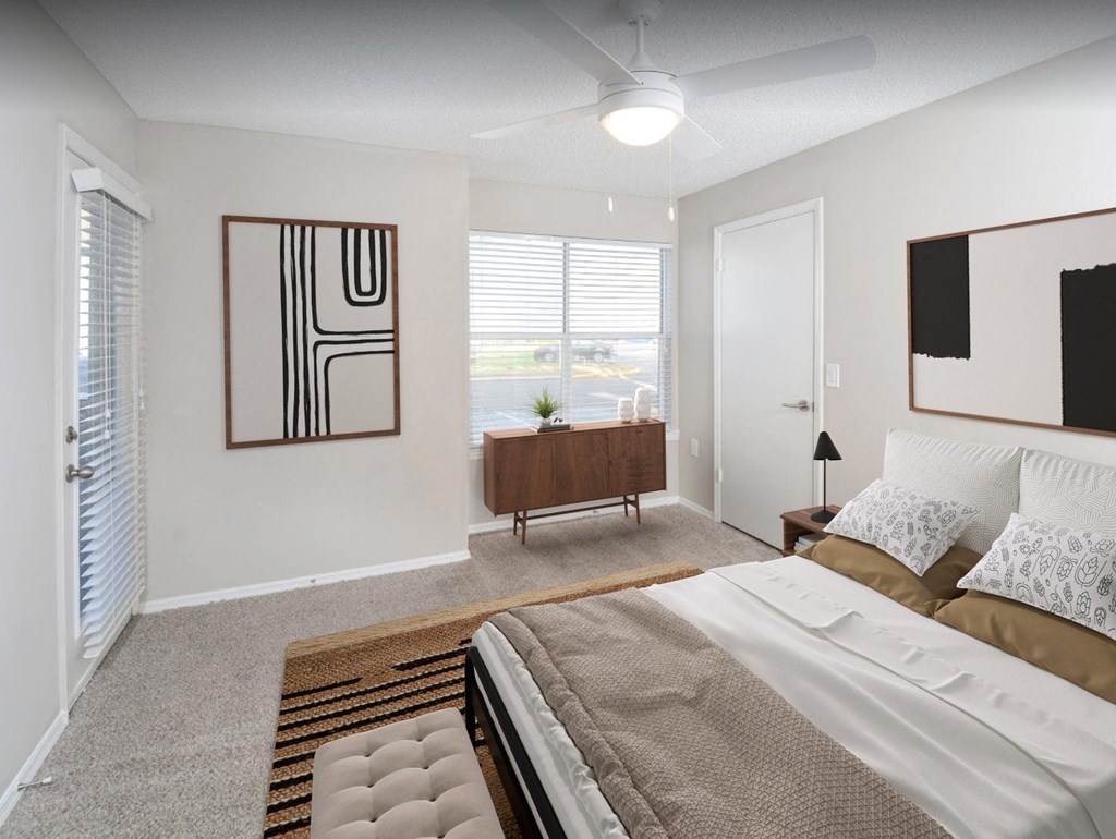a bedroom with a large bed and a large window