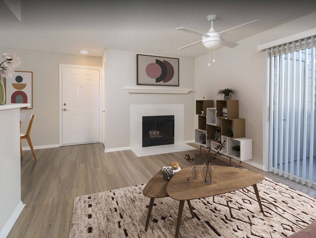 a living room with a fireplace and a ceiling fan