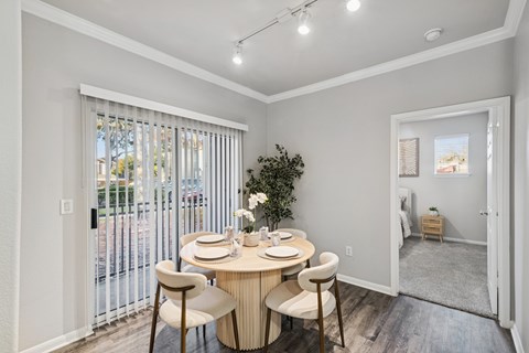 A dining room with a round table and chairs.