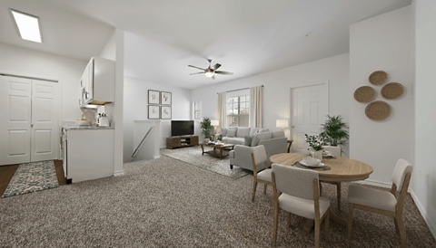 A living room with a dining table and chairs.