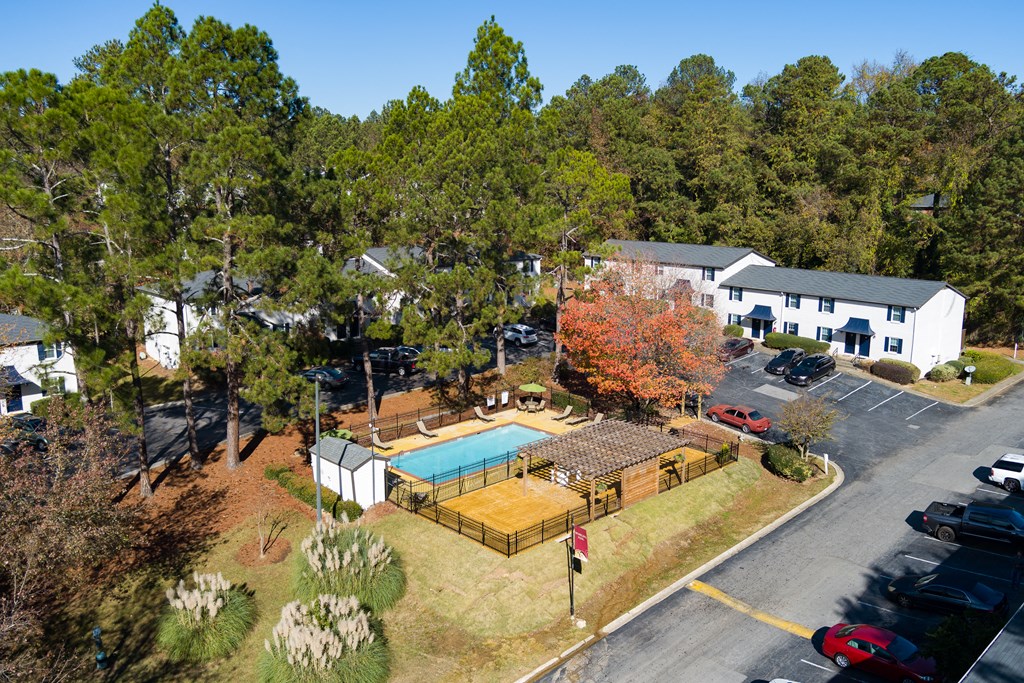an aerial view of a property with a swimming pool and tennis court