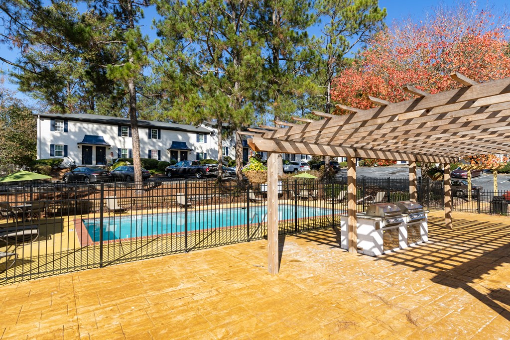 a backyard with a pool and a pergola
