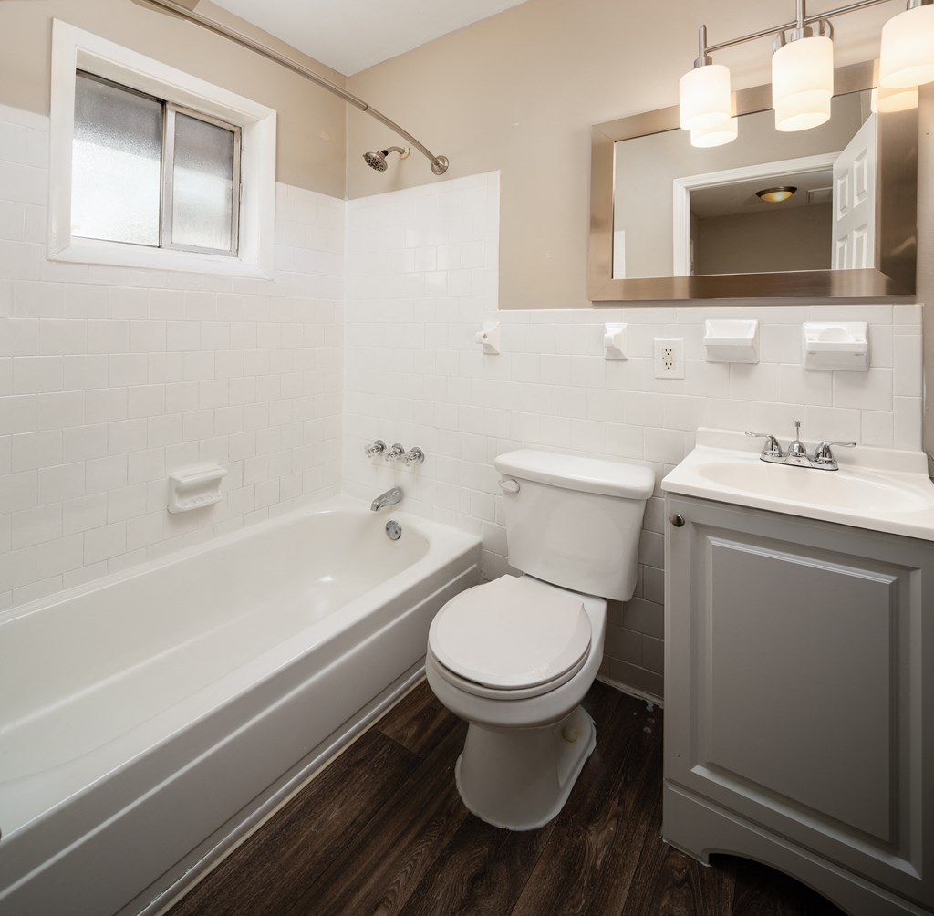 a bathroom with a toilet sink and bathtub