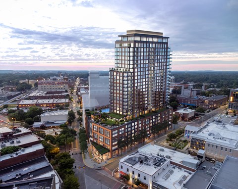 A tall building with a lot of windows is in the center of the image.