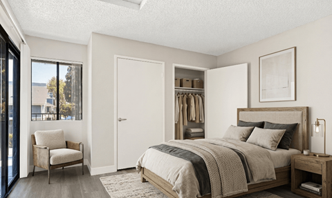 A bedroom with a bed, chair, and a window overlooking a city.
