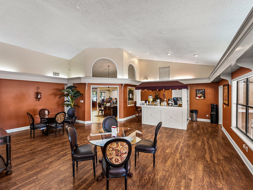 A dining room with a table set for six.