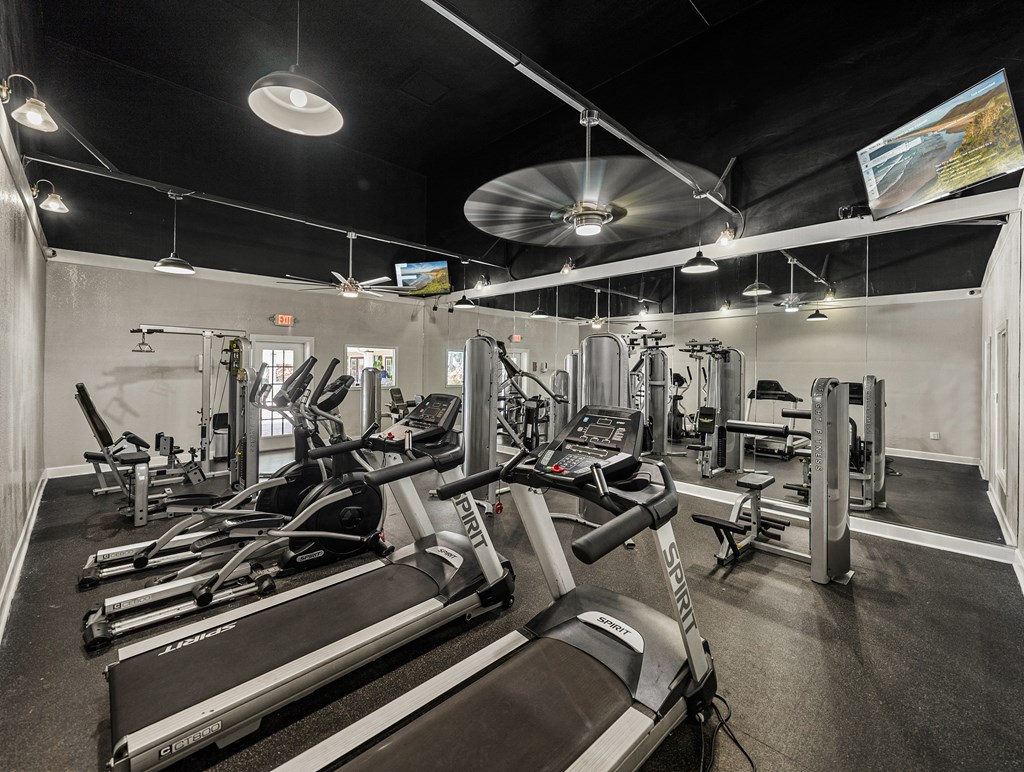 A gym with treadmills and other exercise equipment.