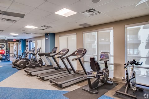an indoor gym with cardio equipment and exercise machines