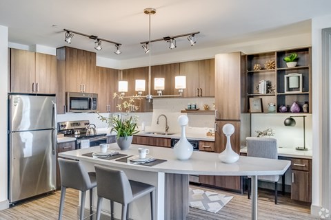 A modern kitchen with a dining table and chairs.