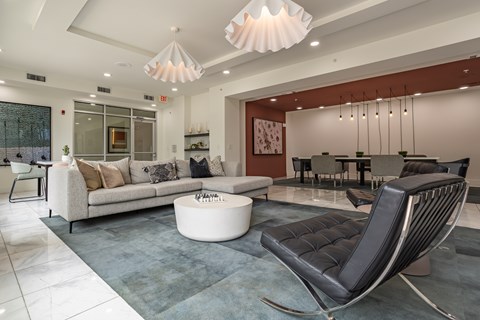 A modern living room with a black leather chair and a white coffee table.