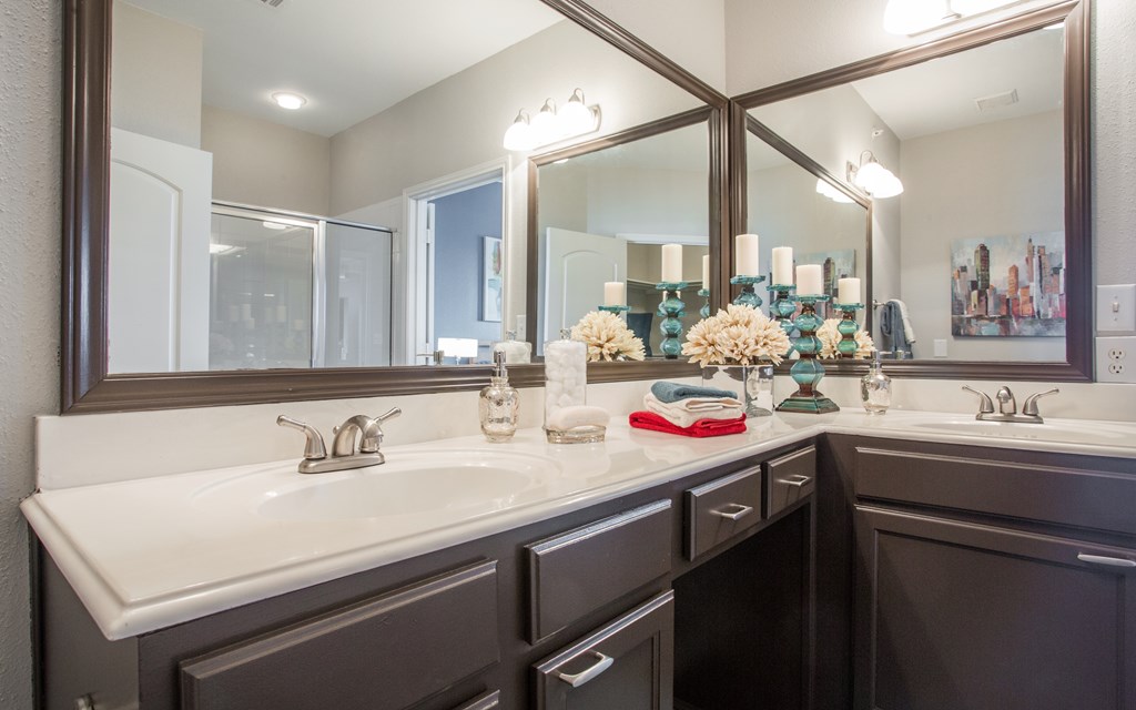 A bathroom with two sinks and a large mirror.