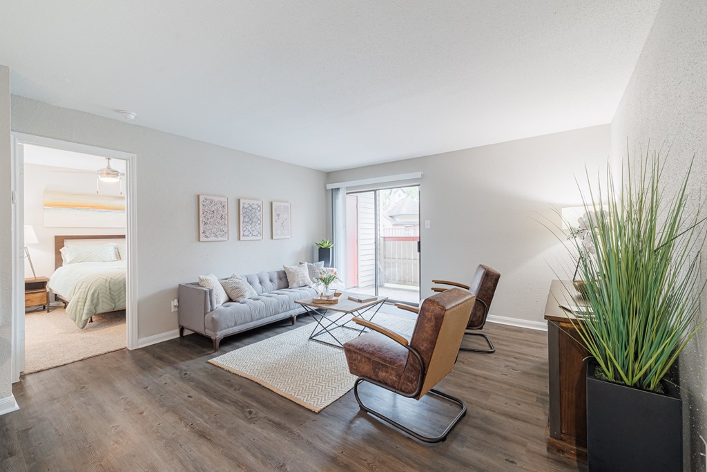 A living room with a grey couch and a brown chair.
