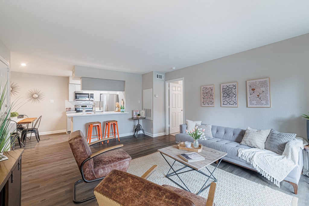 A living room with a grey couch and a brown chair.