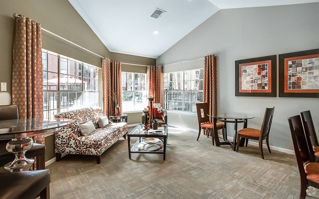 a living room and dining room with a table and chairs