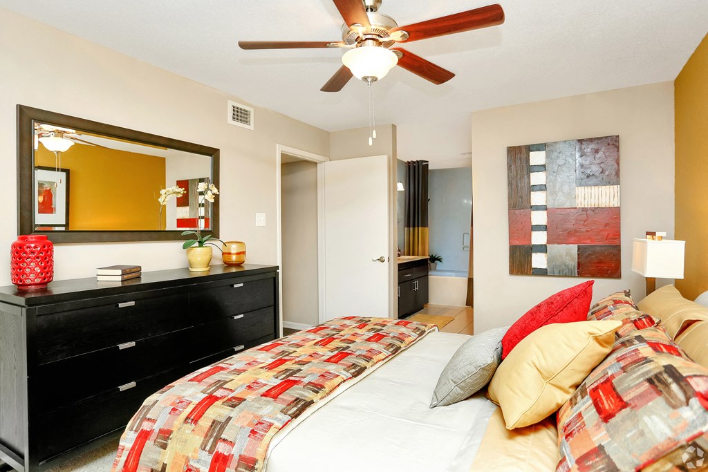 a bedroom with a bed and a ceiling fan