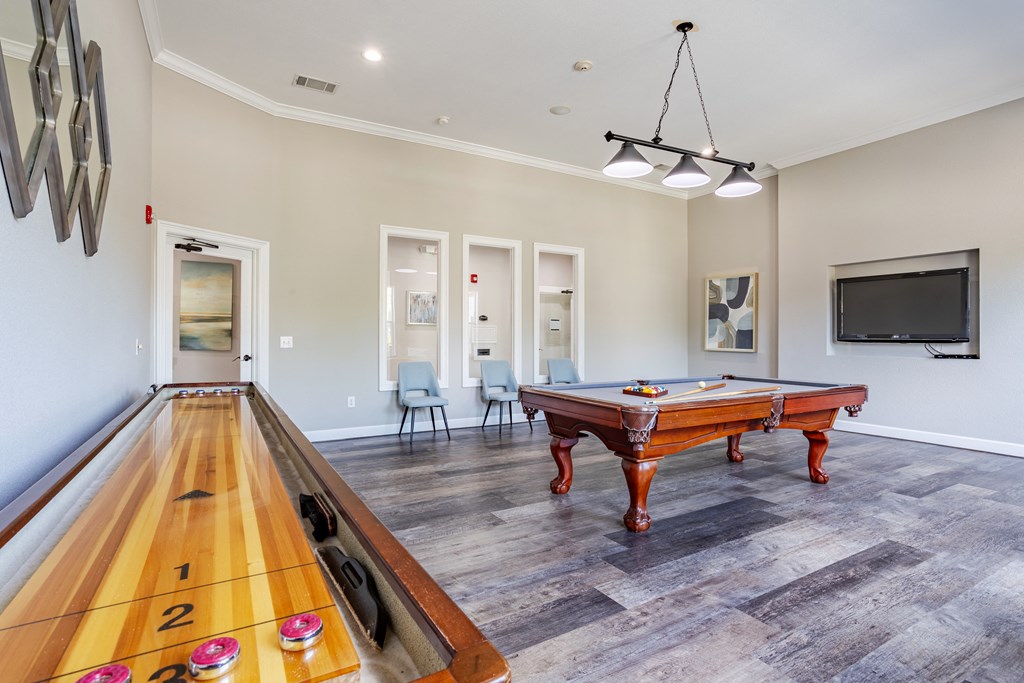 a game room with a pool table and a bowling alley