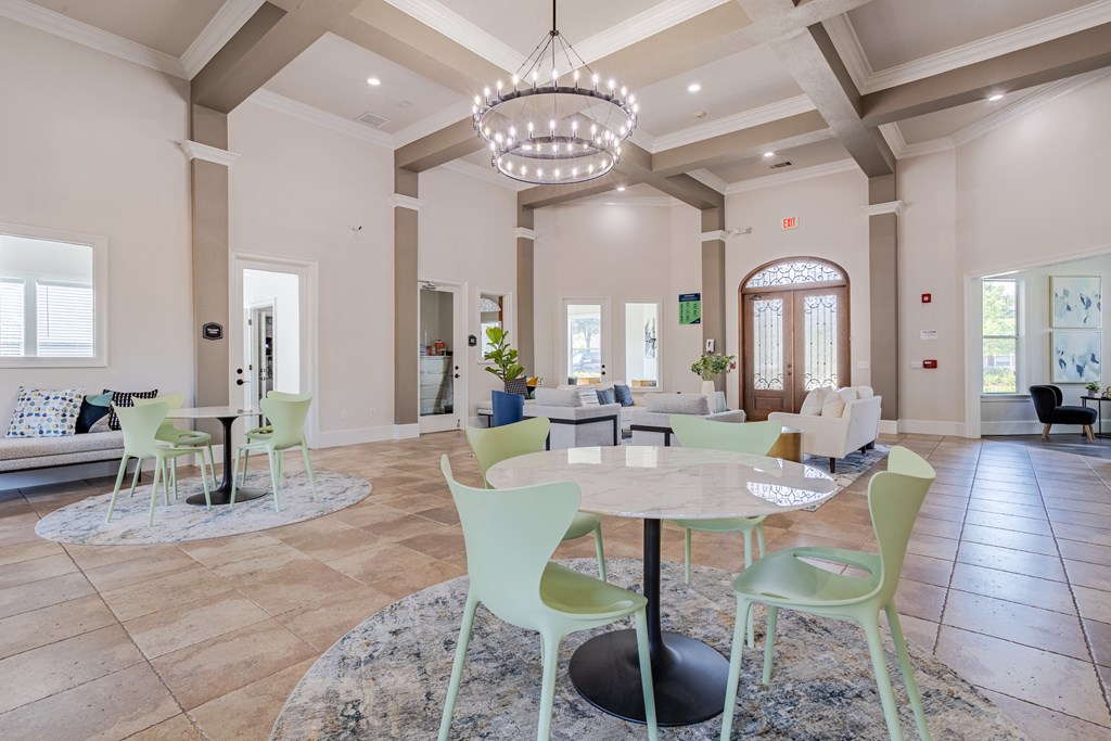 a dining room with tables and chairs and a chandelier