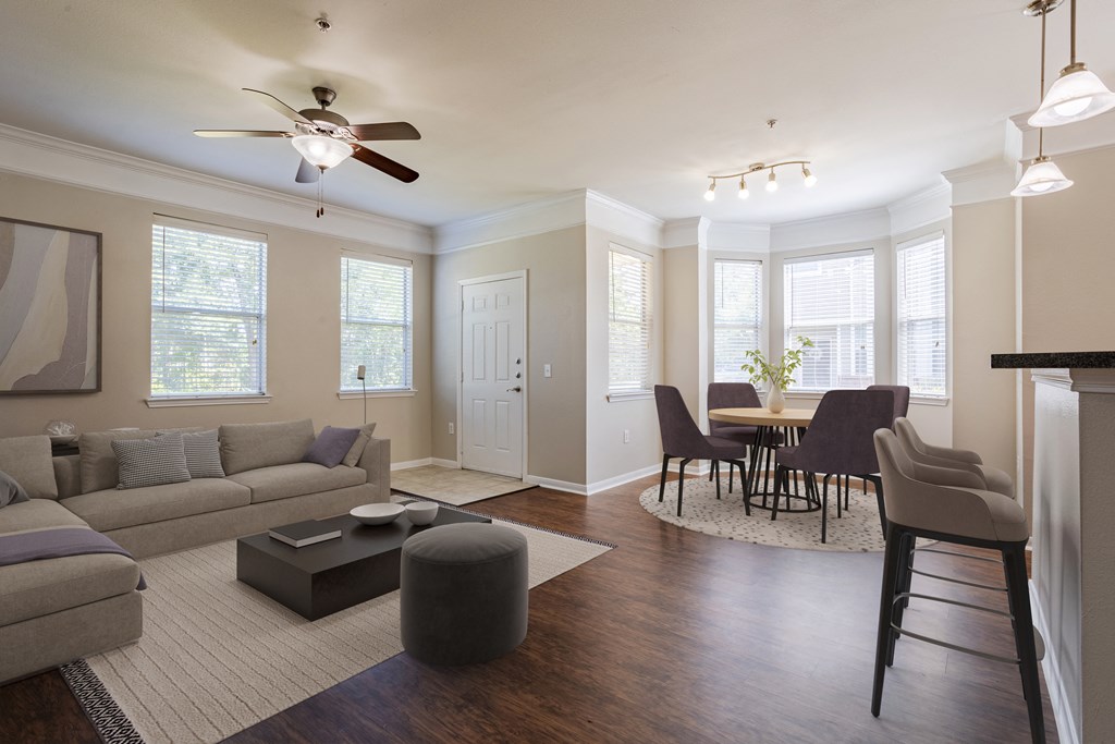 a living room with a couch and a table with chairs