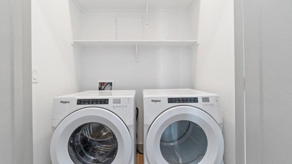 a washer and dryer in a laundry room with white walls