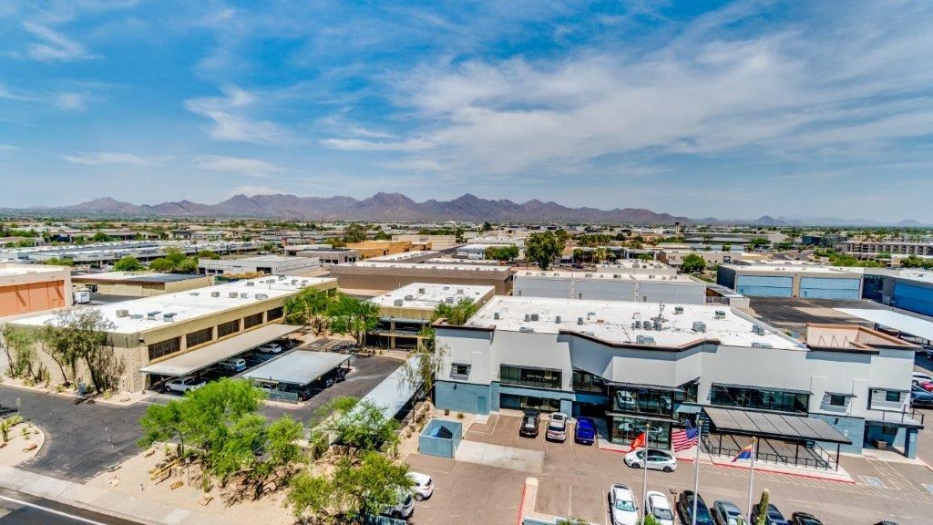 an aerial view of a parking lot and buildings in the desert