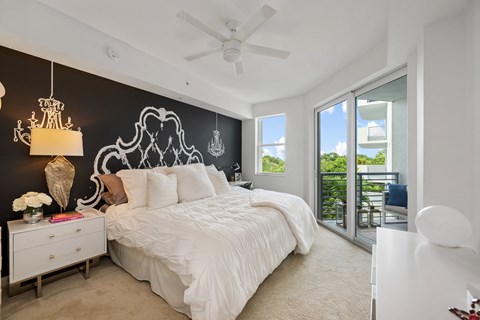 a bedroom with a large bed and a ceiling fan
