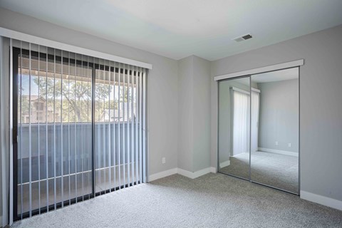 the master bedroom has sliding glass doors to the patio