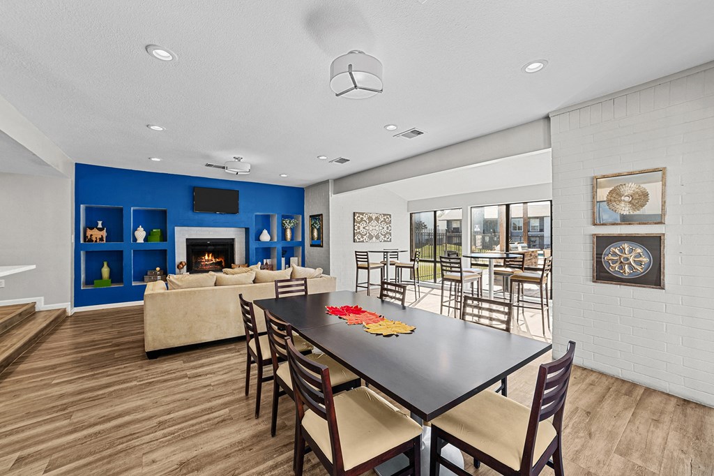 A modern dining room with a black table and chairs.