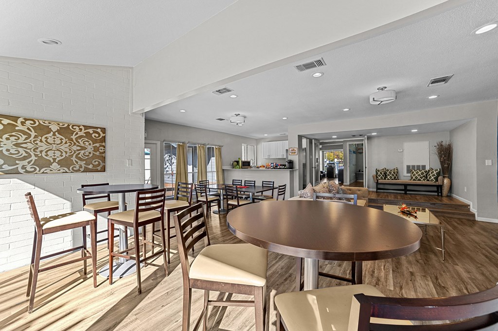 A modern dining room with a large table and chairs.