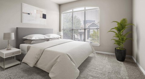 A bedroom with a large bed, a nightstand with a lamp, and a potted plant.