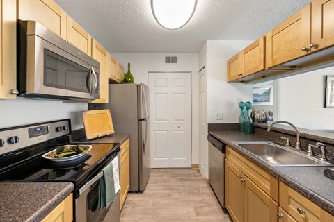 a kitchen with stainless steel appliances and granite counter tops