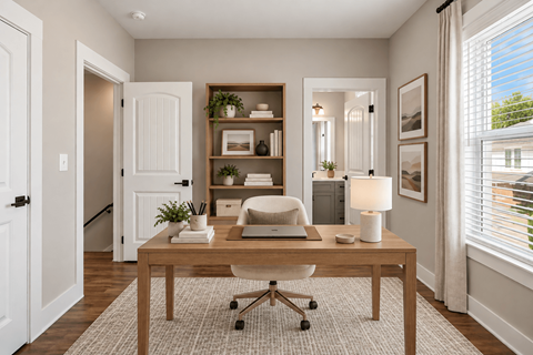 A well-lit room with a desk, chair, and shelves with decorative items.