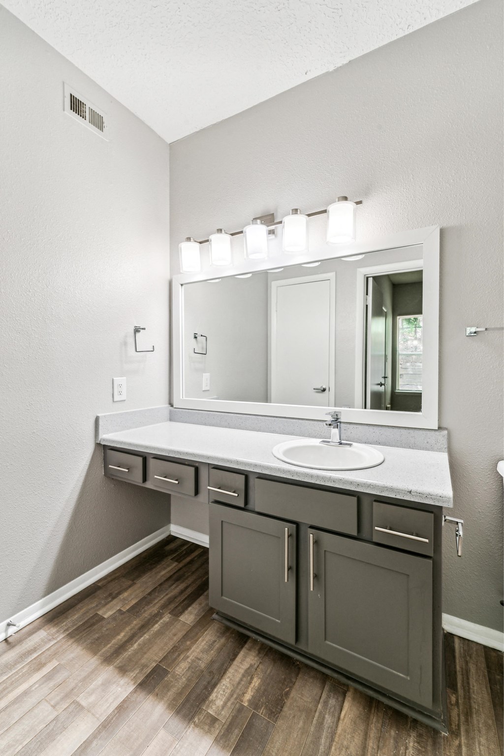 the retreat apartments renovated bathroom with sink and mirror