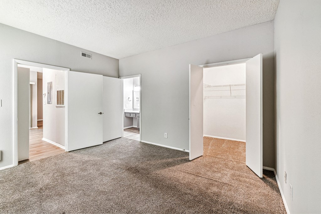 an empty living room with white walls and a carpeted floor
